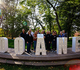 Doane University Alumni Group With Doane Sign Daytime